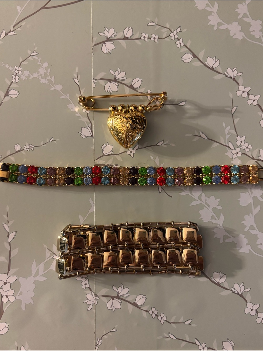 2 bracelets and heart pin